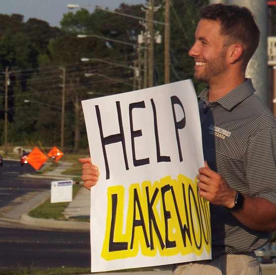 Chase LaRue holding a sign