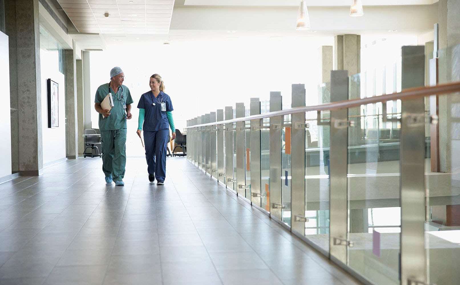 Image of two medical providers walking down a hall