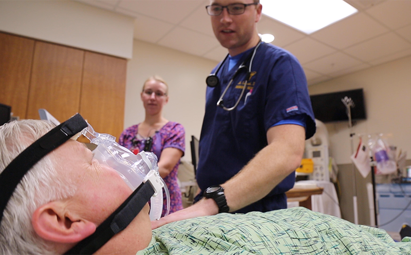 healthcare providers and patient in hospital bed