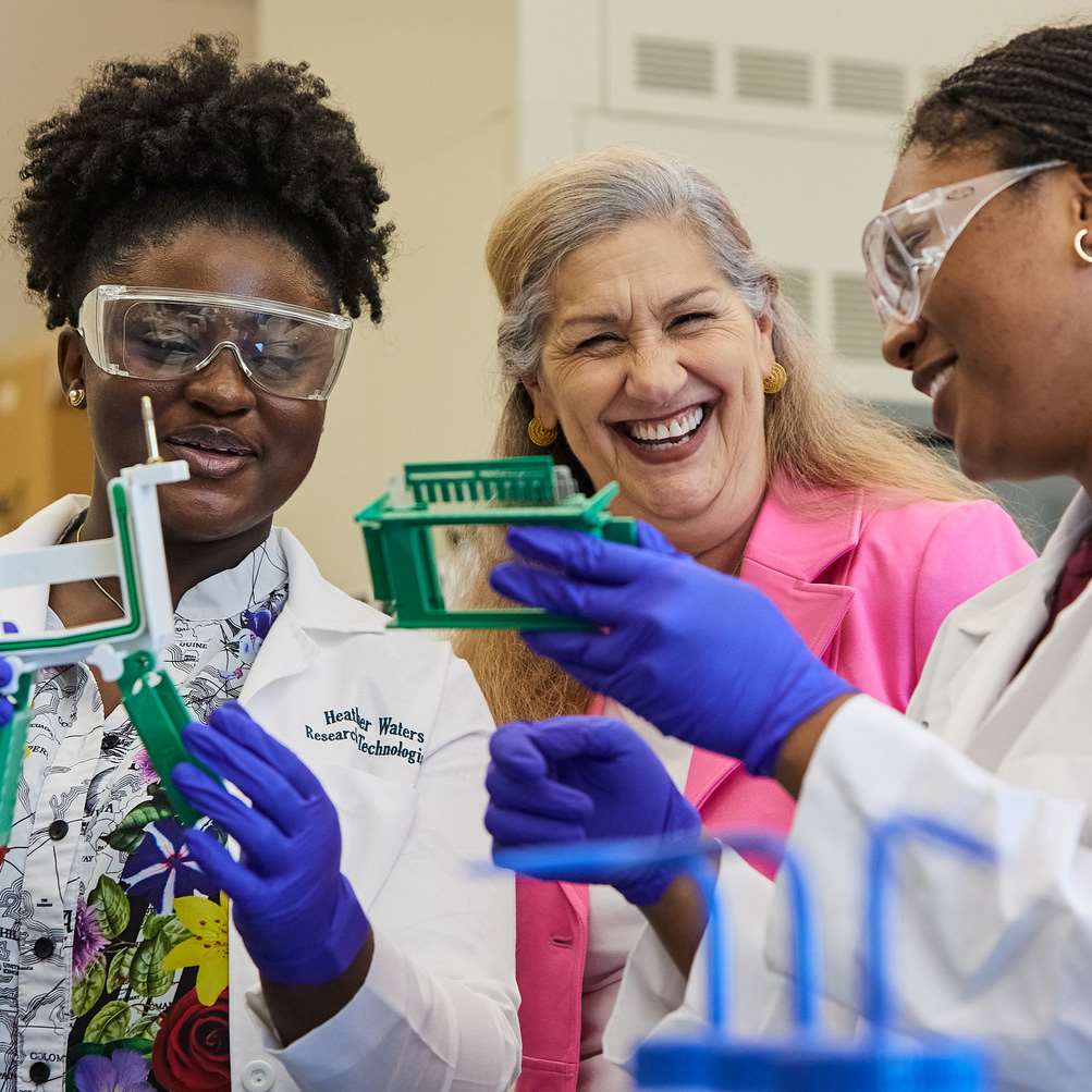 Three women researchers laughing