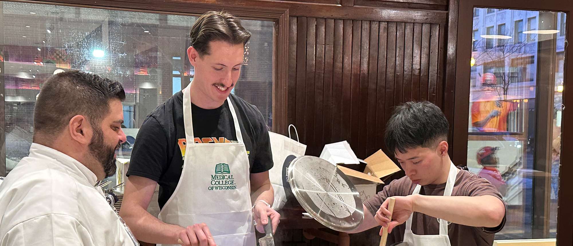Three men cooking