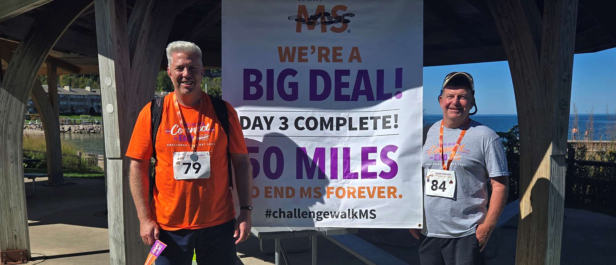 Two men standing in front of a banner