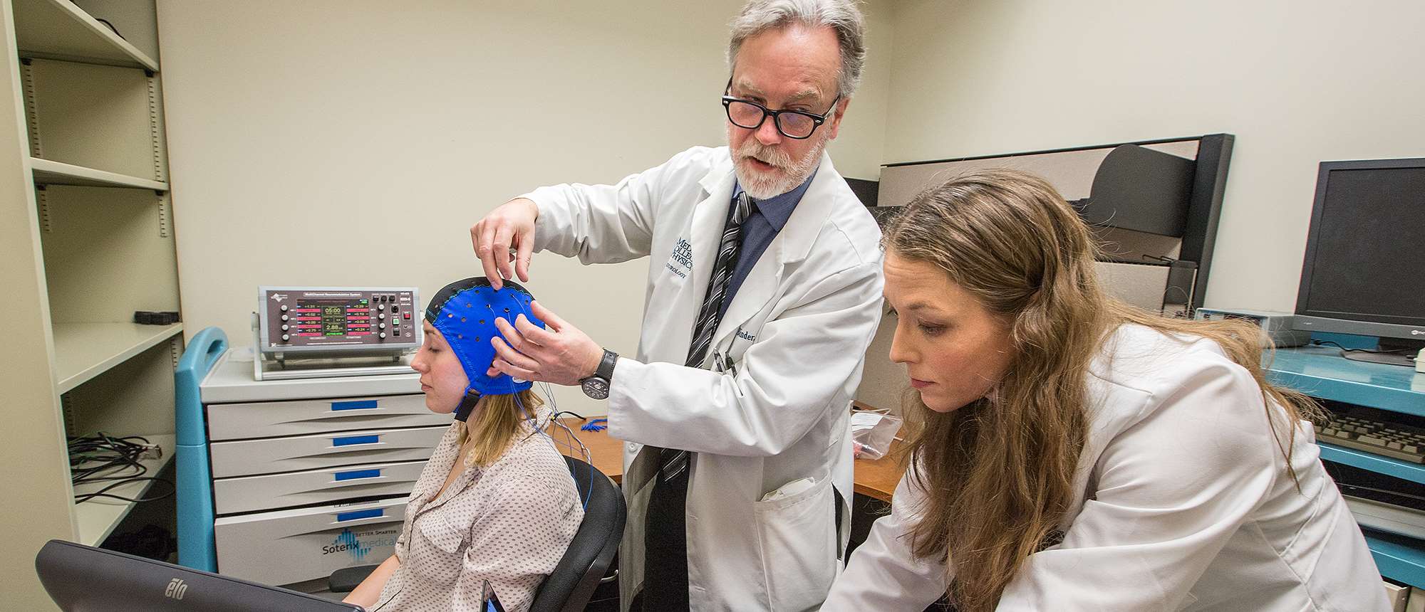 Two doctors working with an aphasia patient