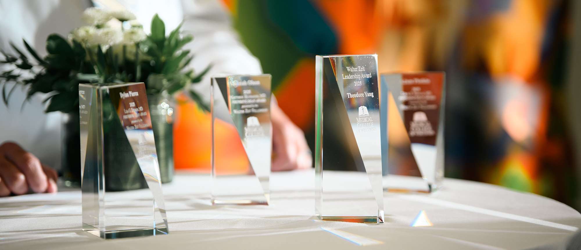 Four glass awards on table