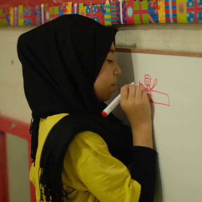 Girl writing on a wall