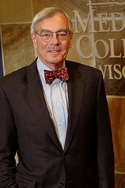 Michael J. Dunn, MD '62, MCW Dean Emeritus, standing in HRC