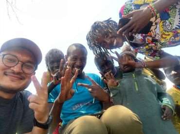 Student and Kenyan people taking selfie