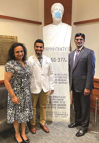 Drs. Kodali and Mathai with their son, Rajiv, at his MCW White Coat Ceremony in 2021.