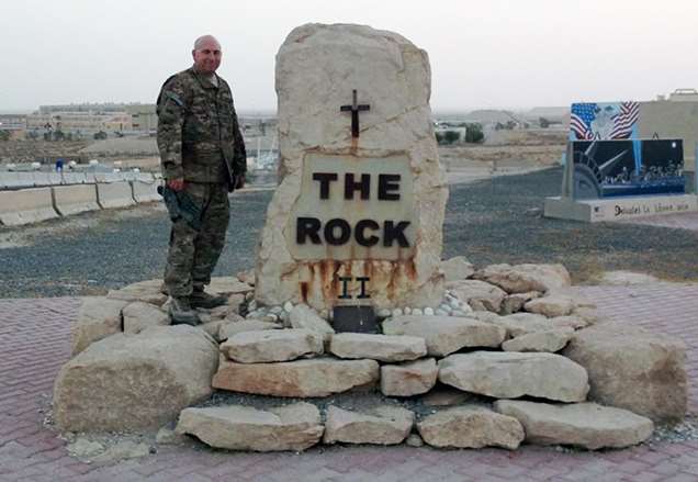 Dr. Lewis Somberg standing at memorial