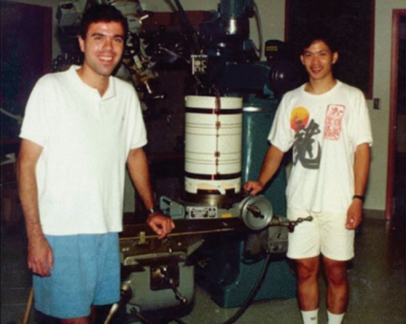 two individuals standing with equipment