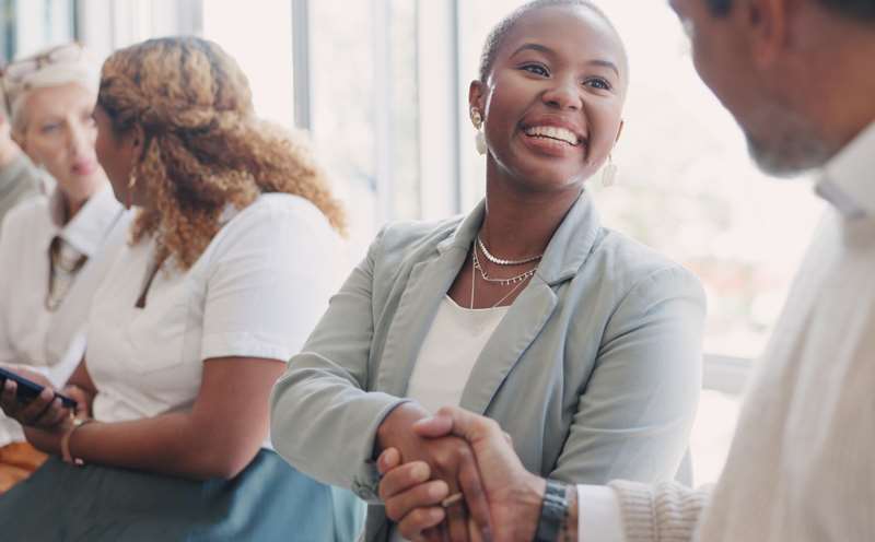 Woman shaking hands with man