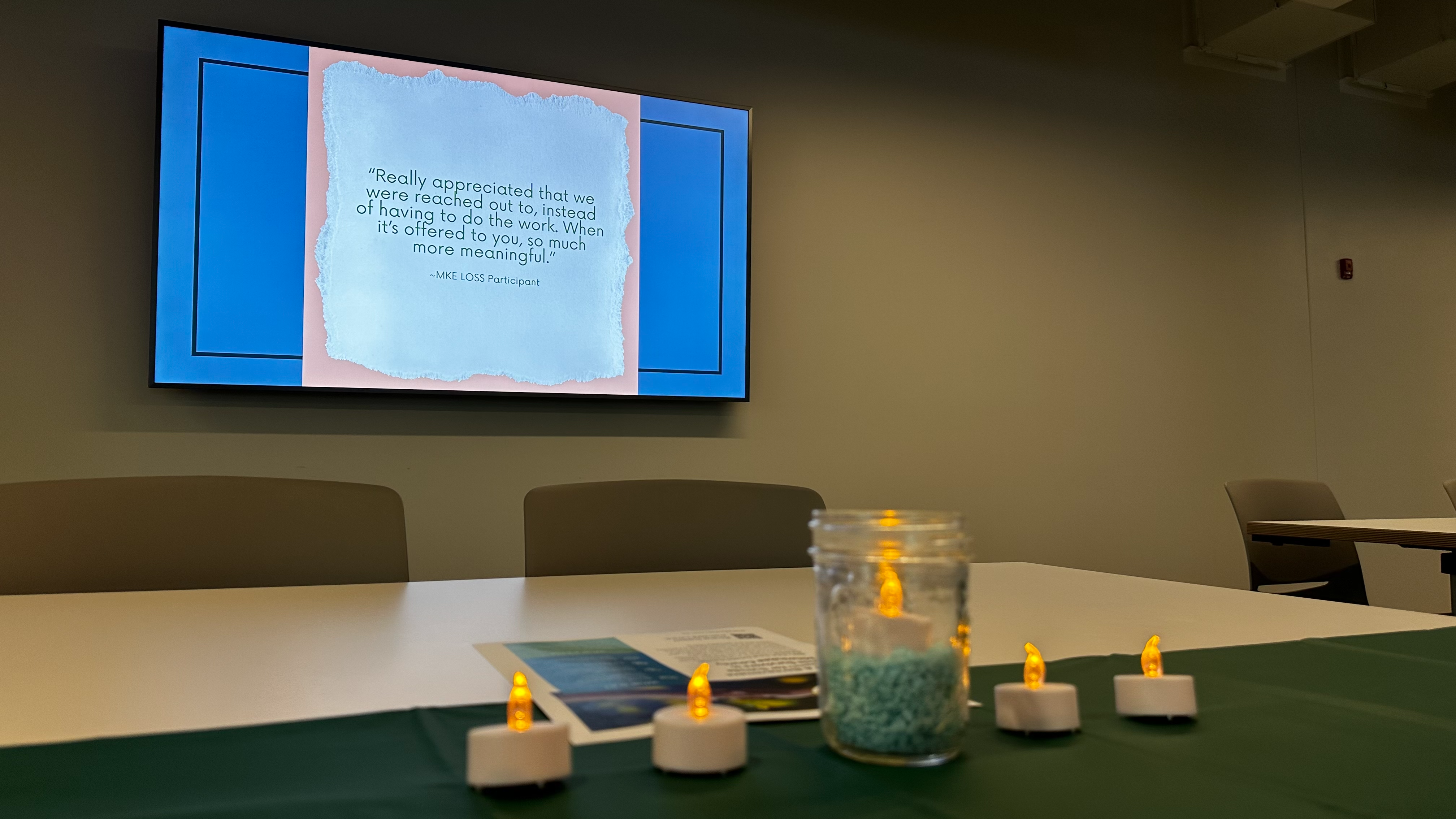 Educational Slide from Postvention Course with lit votive candles in foreground
