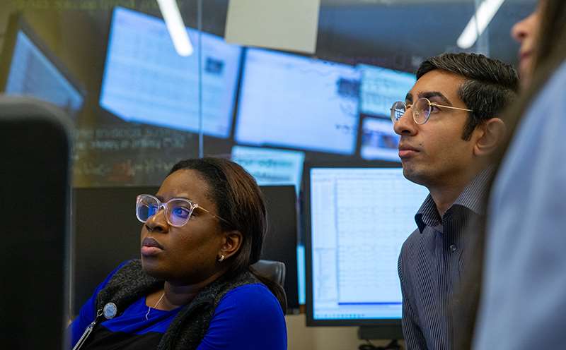 Two women and a man in an educational setting