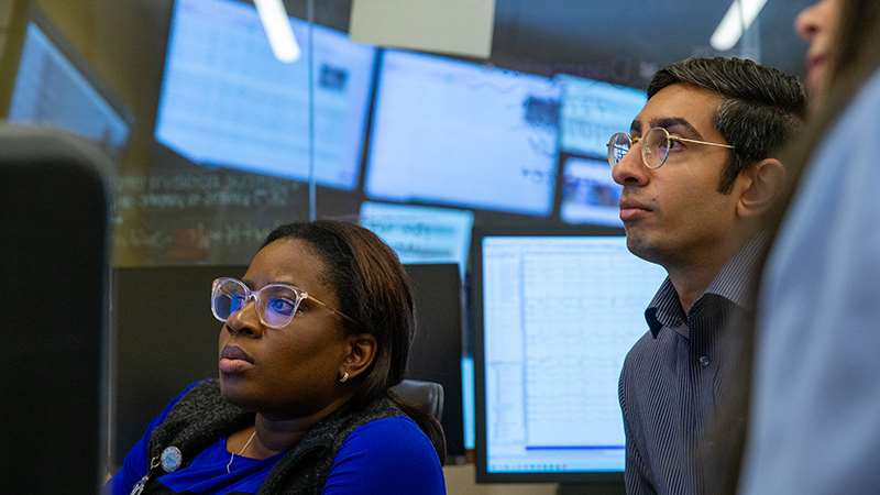 Two women and a man in an educational setting