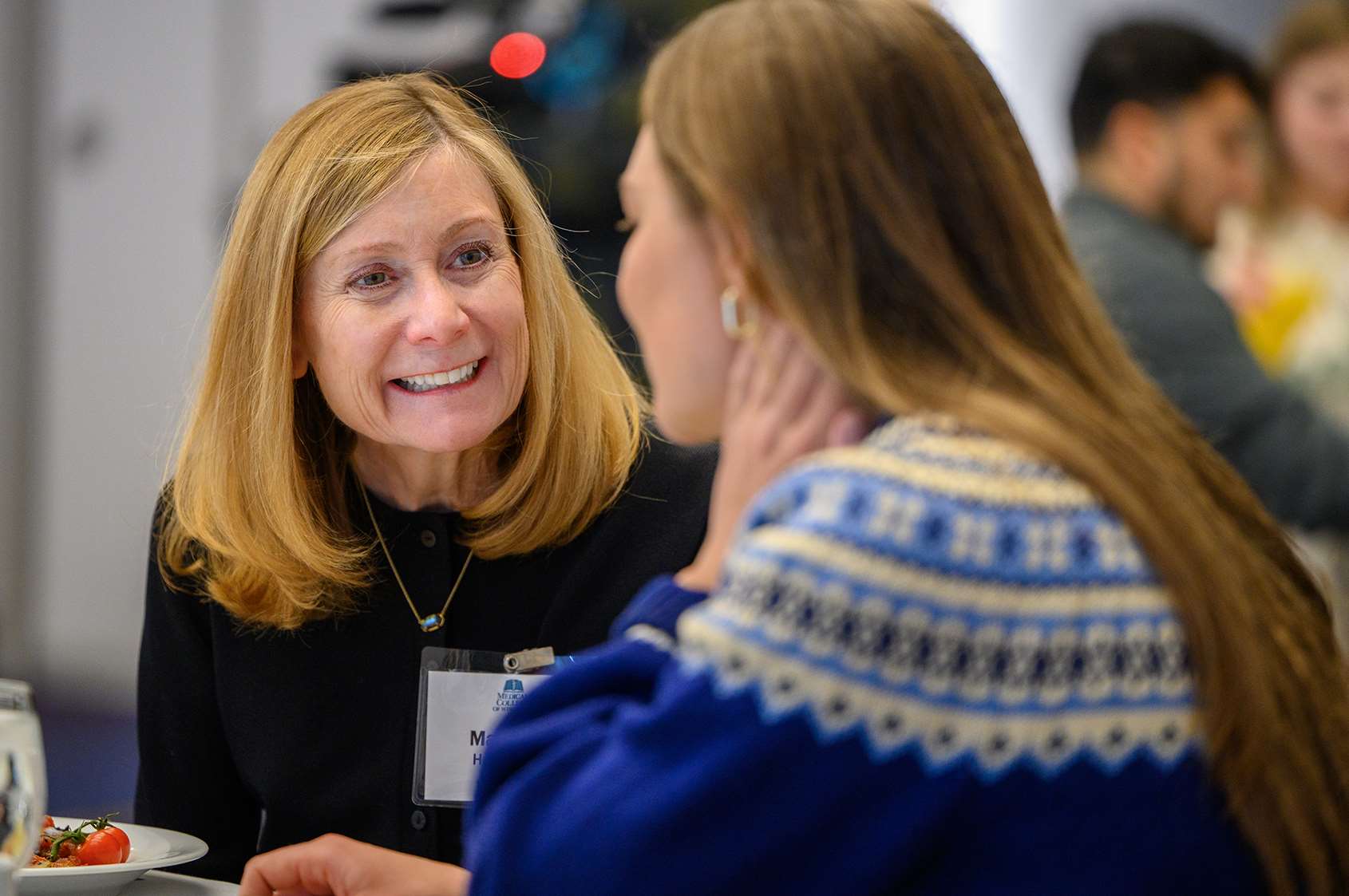 Margaret Haagensen conversing with a MCW student