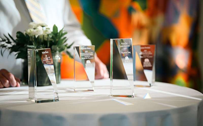 Four glass awards on table