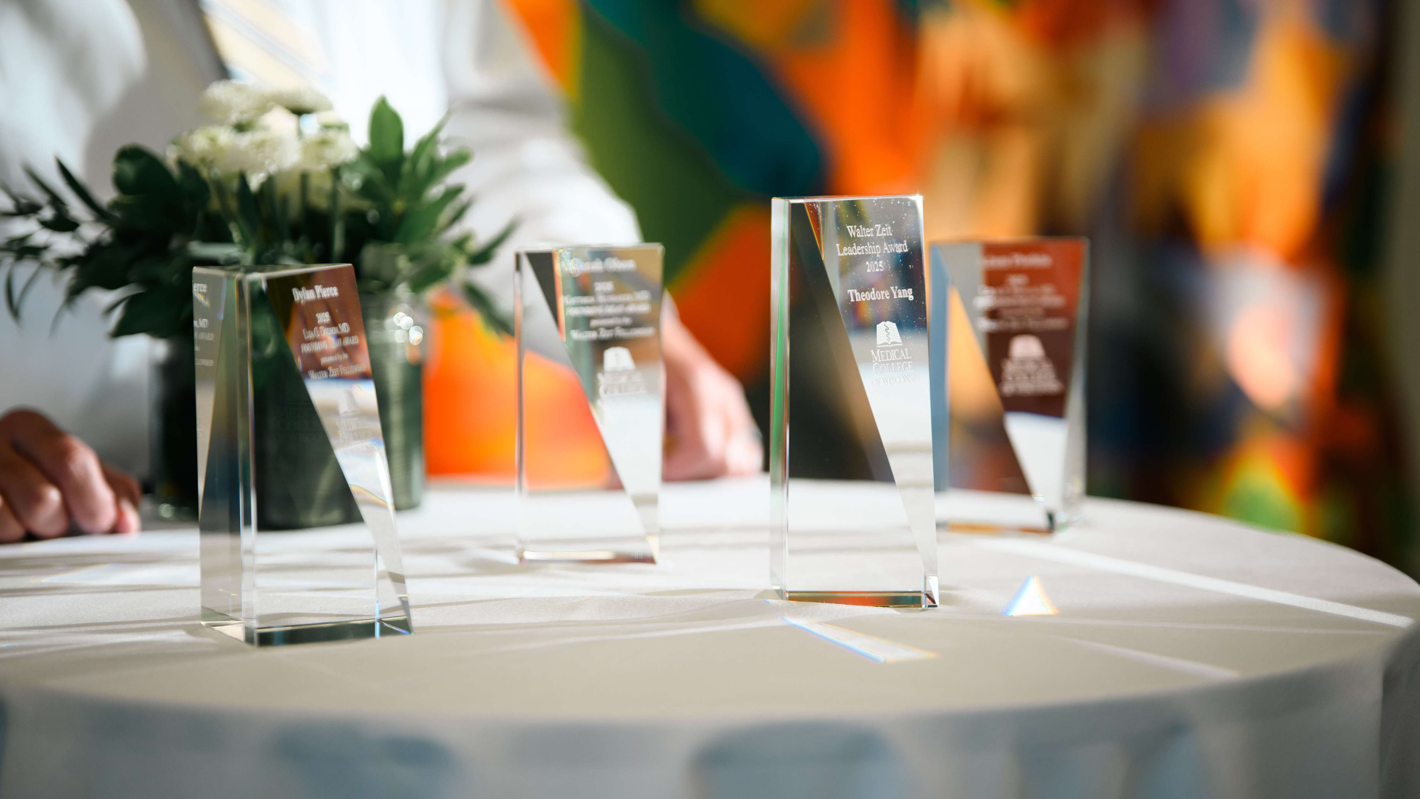 Four glass awards on table
