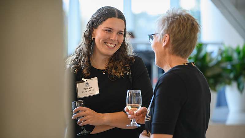 Two women talking at an event