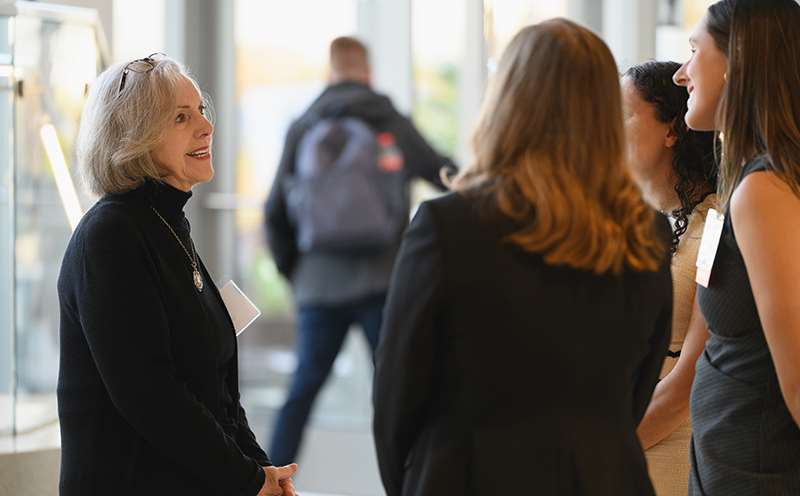 Four women talking in hallway