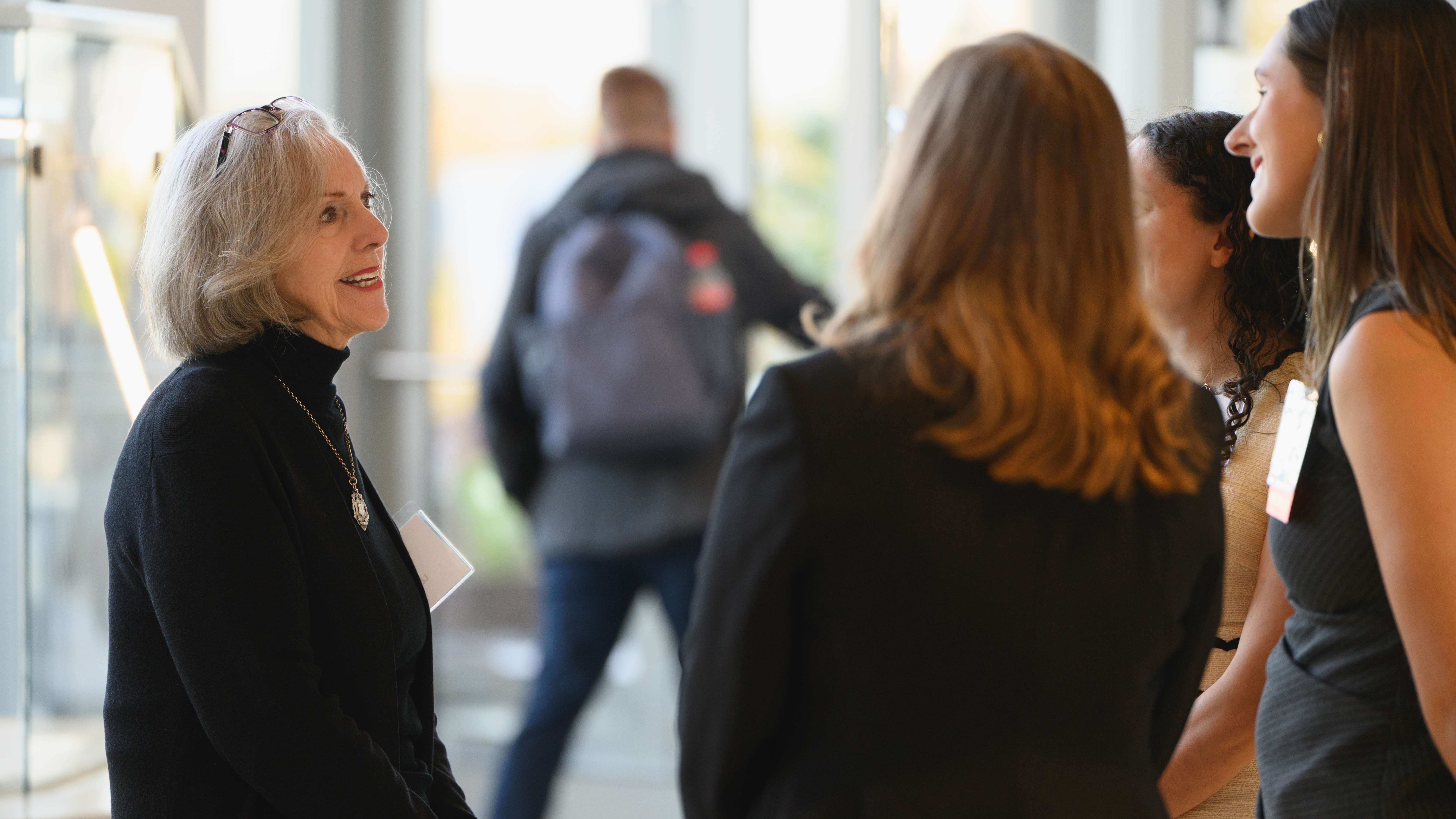 Four women talking in hallway