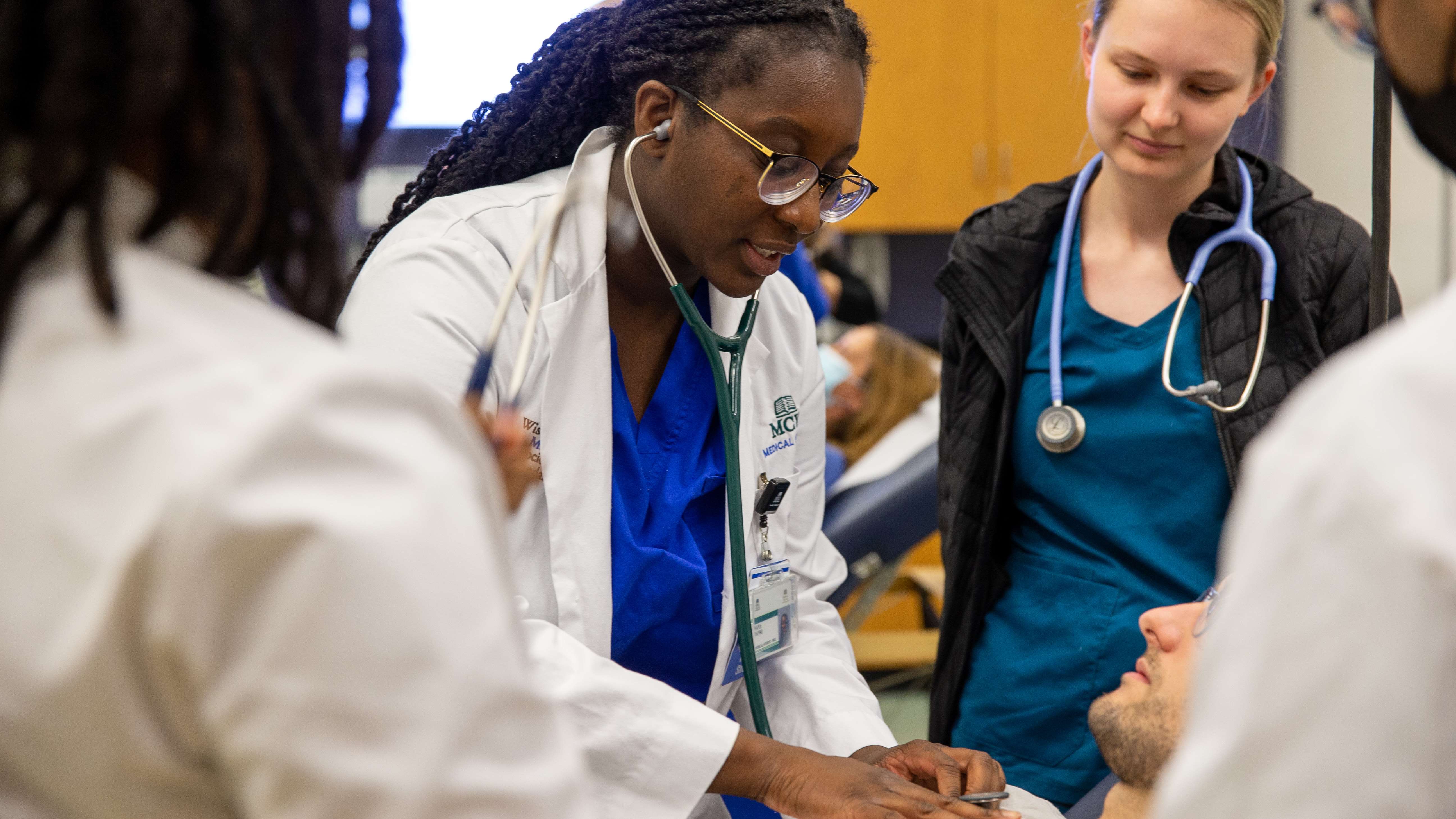 Medical students simulating a patient exam