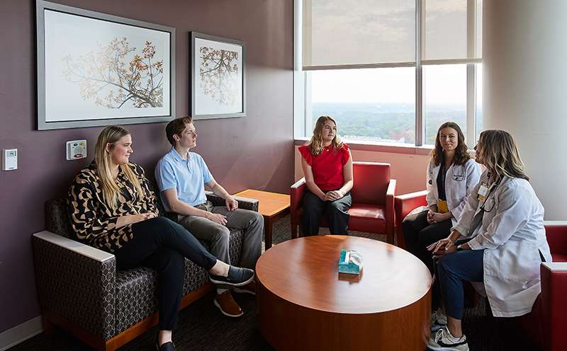 Five people talking around a table.