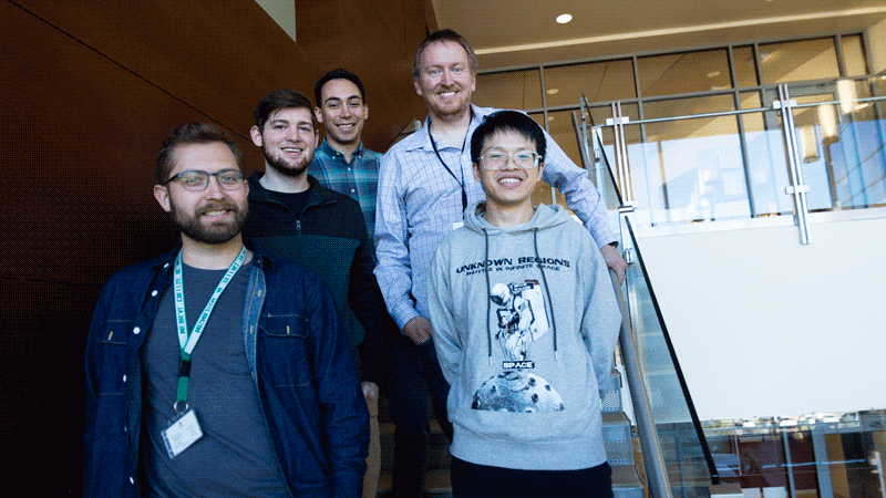 Researchers and students of PDAT Lab standing on staircase