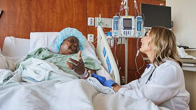 A provider comforts a female hospital patient