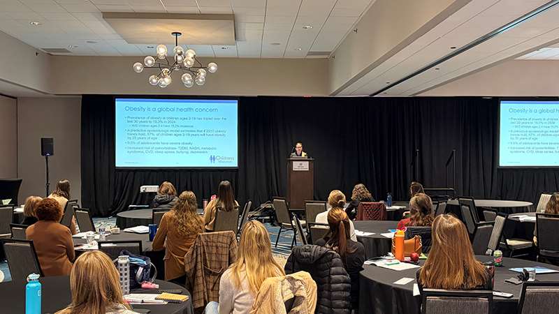 Presenter and attendees at a conference