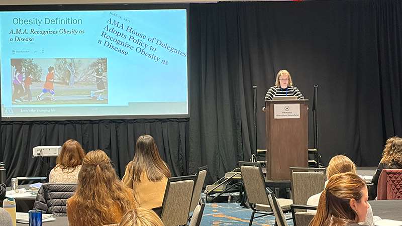 Presenter and attendees at a conference