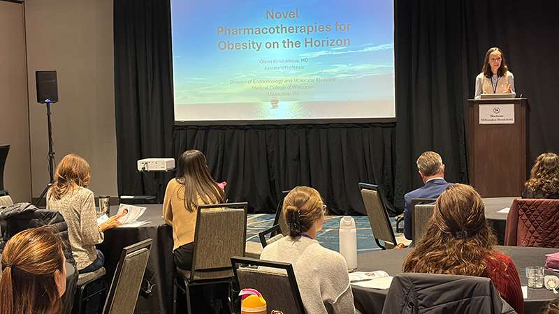 Presenter and attendees at a conference