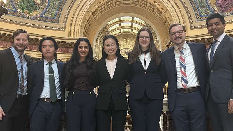 Seven people standing inside a building