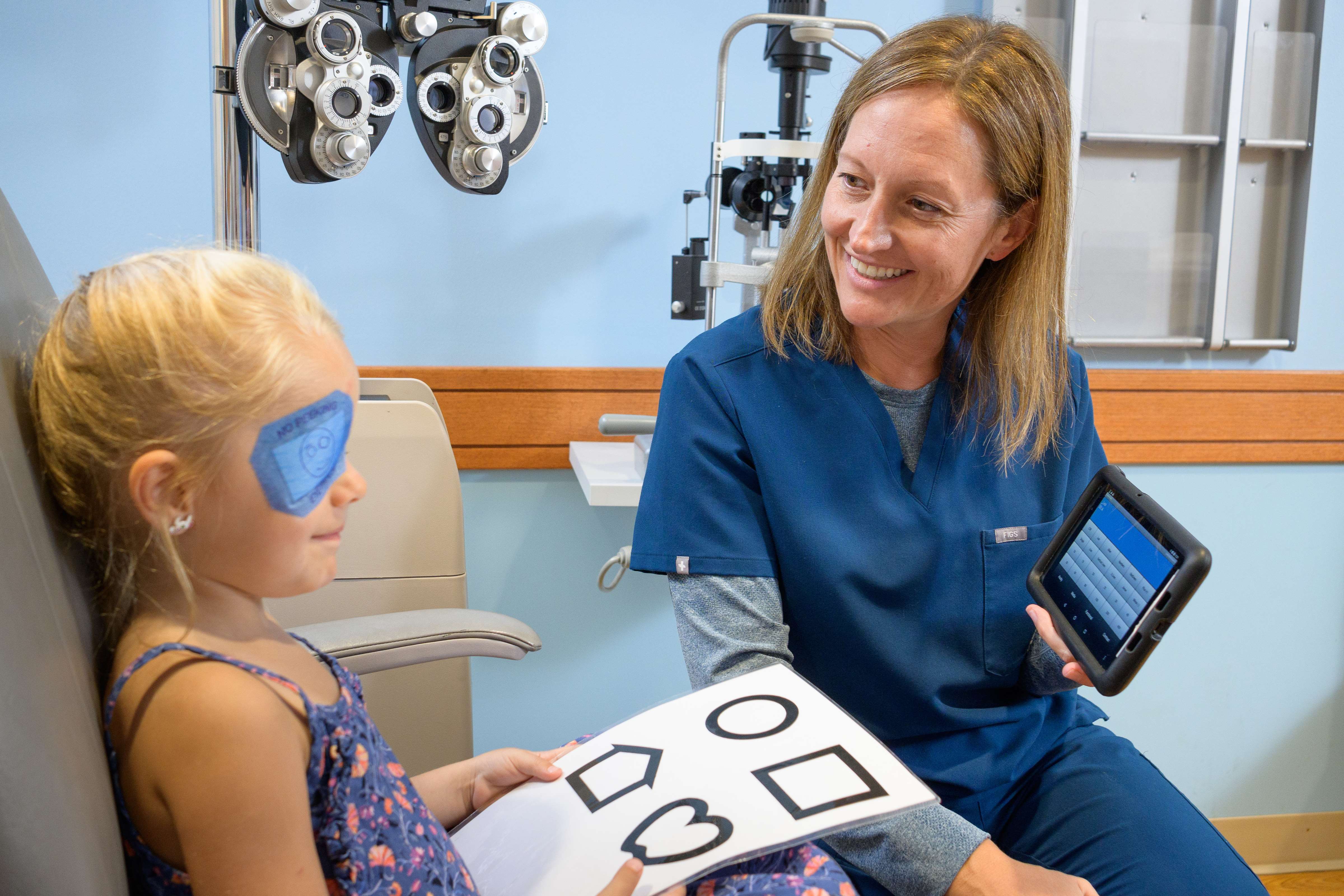 Pediatric optometrist with patient