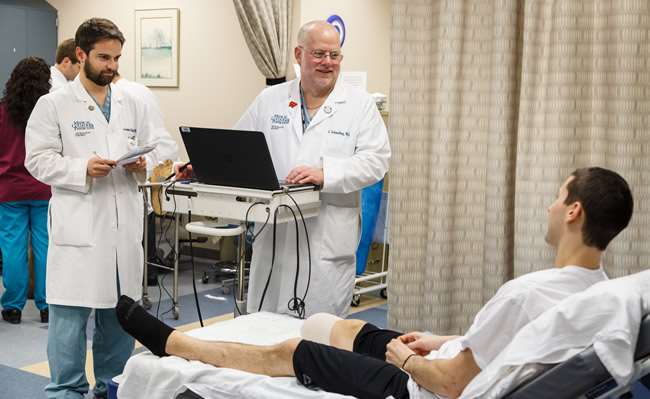 Orthopaedic Trauma Clinic two male doctors with patient