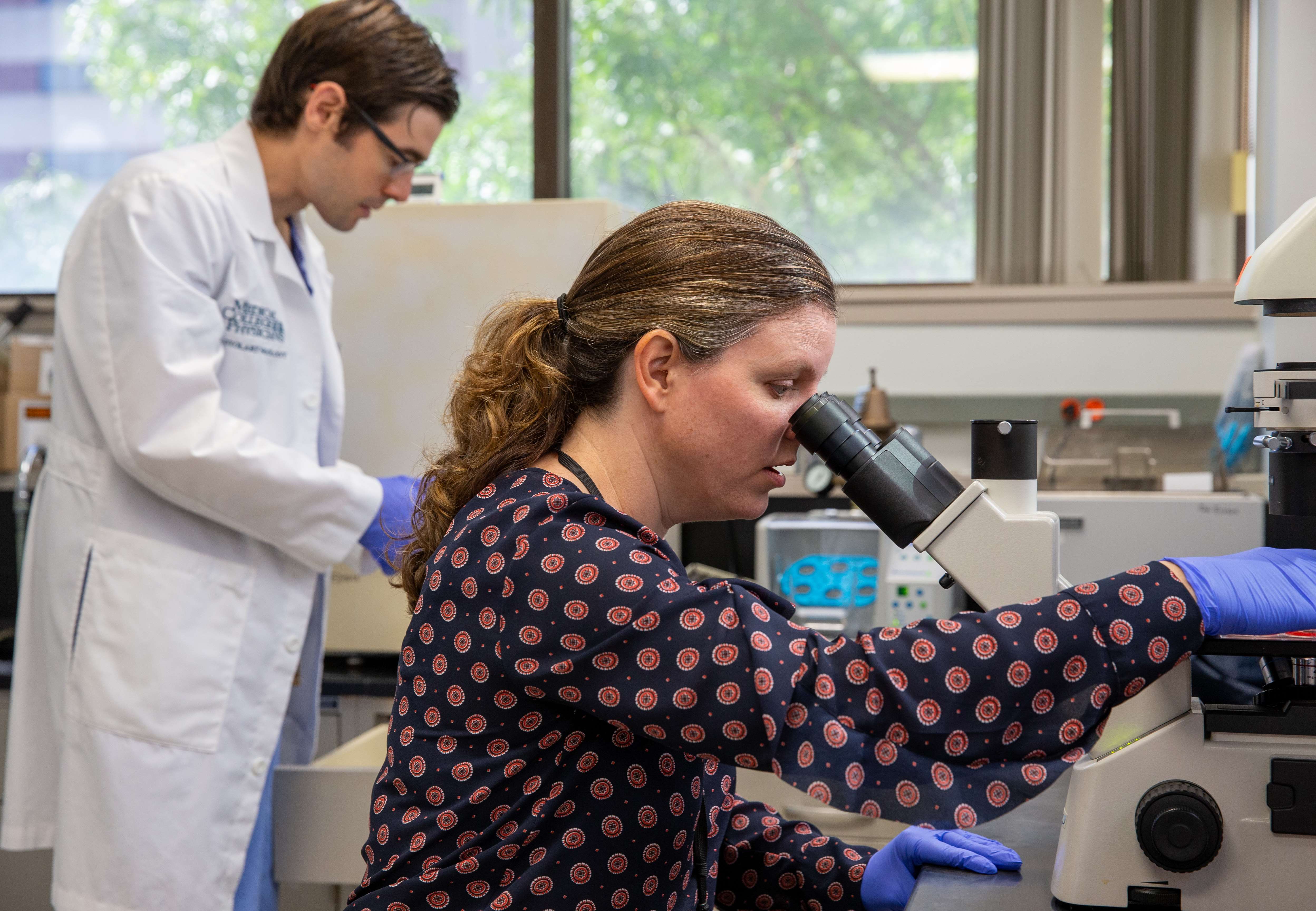 Otolaryngology doctor and researcher in lab