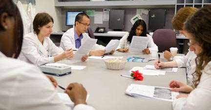 medical professionals sitting around table