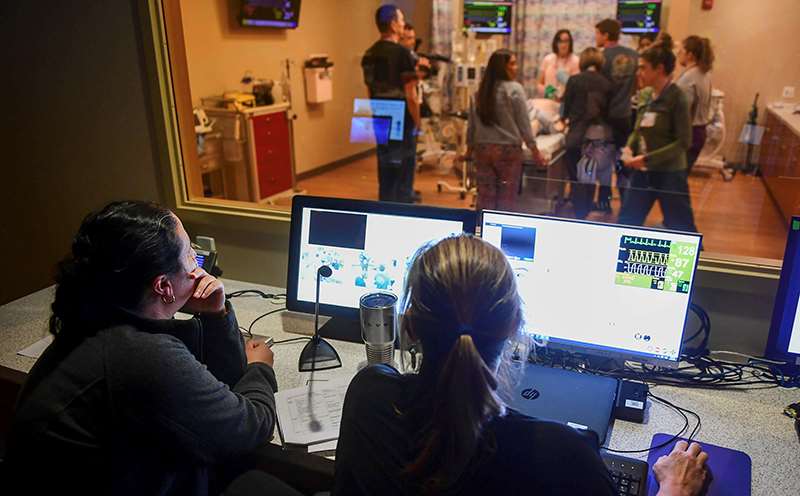 Pediatric staff running and observing a simulation care experience.