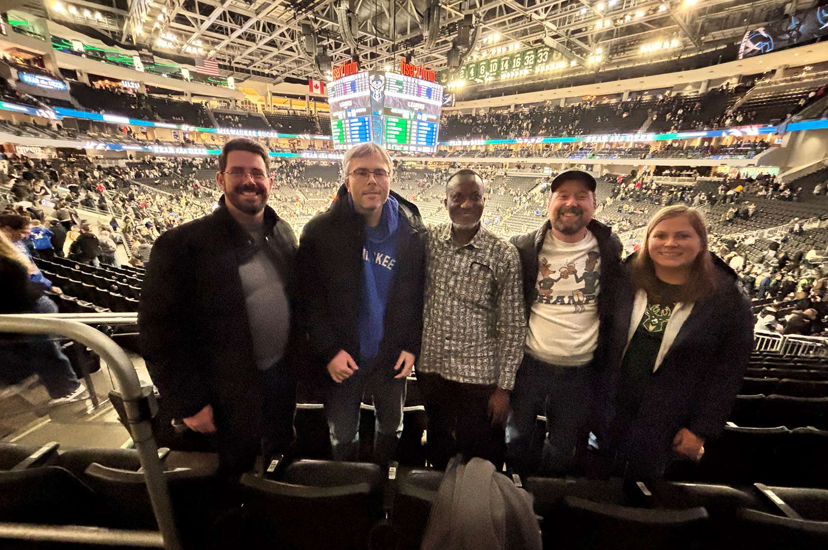 Chris, Maciej, Kwabena, Jesse, and Alex at a Milwaukee Bucks game for a Fellowship fellowship opportunity!