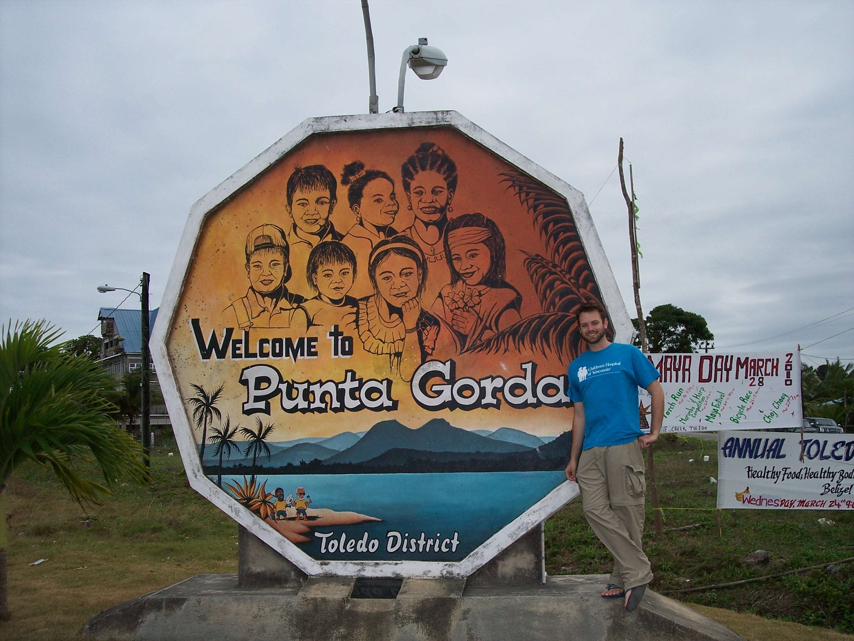 Male standing by a Punta Gorda sign