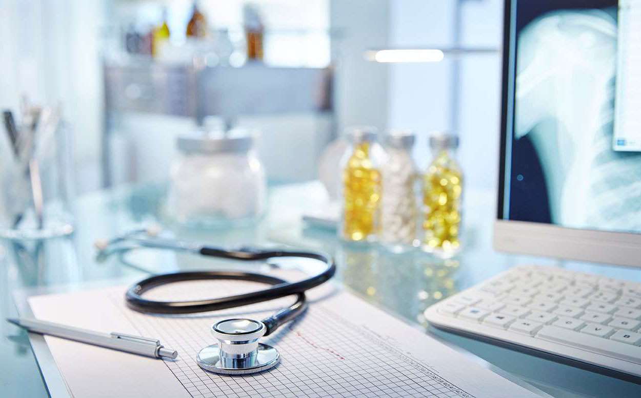 Image of a desk in a medical setting with a stethoscope