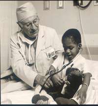 Dr. Marvin Glicklich with a child