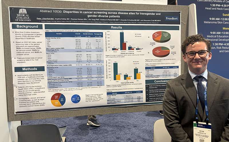 A man standing in front of a research poster