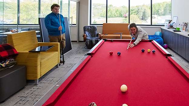 Two people playing pool