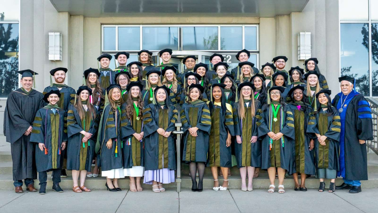 Group photo of the PharmD Class of 2026 wearing graduation gowns and tams on the front steps of the Medical College of Wisconsin.