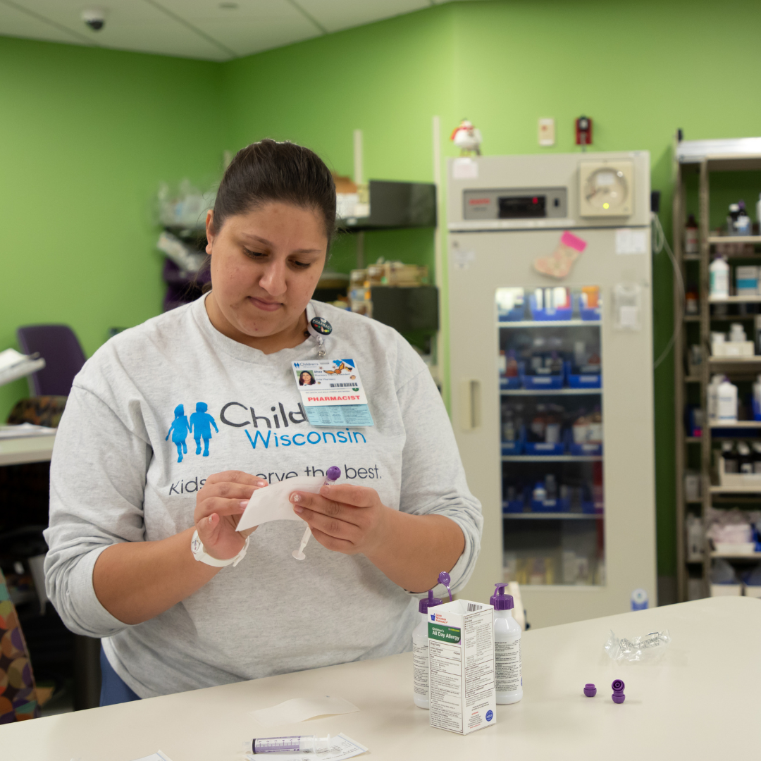 Academic Medical Center Partnerships Woman fills a prescription at the Children's Wisconsin pharmacy.