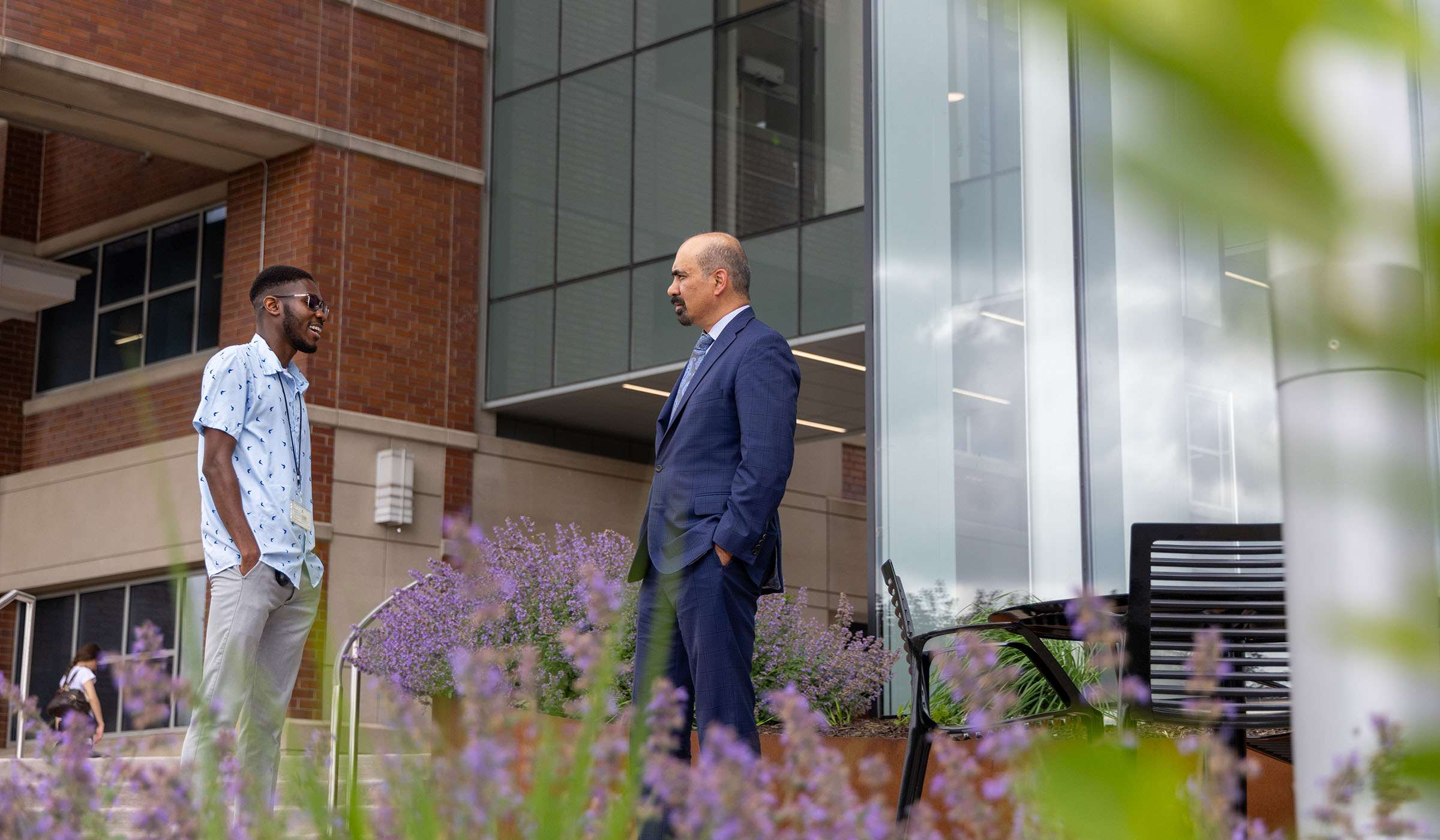 Shekar N. Kurpad, MD, PhD and student standing outside the Medical College of Wisconsin main building