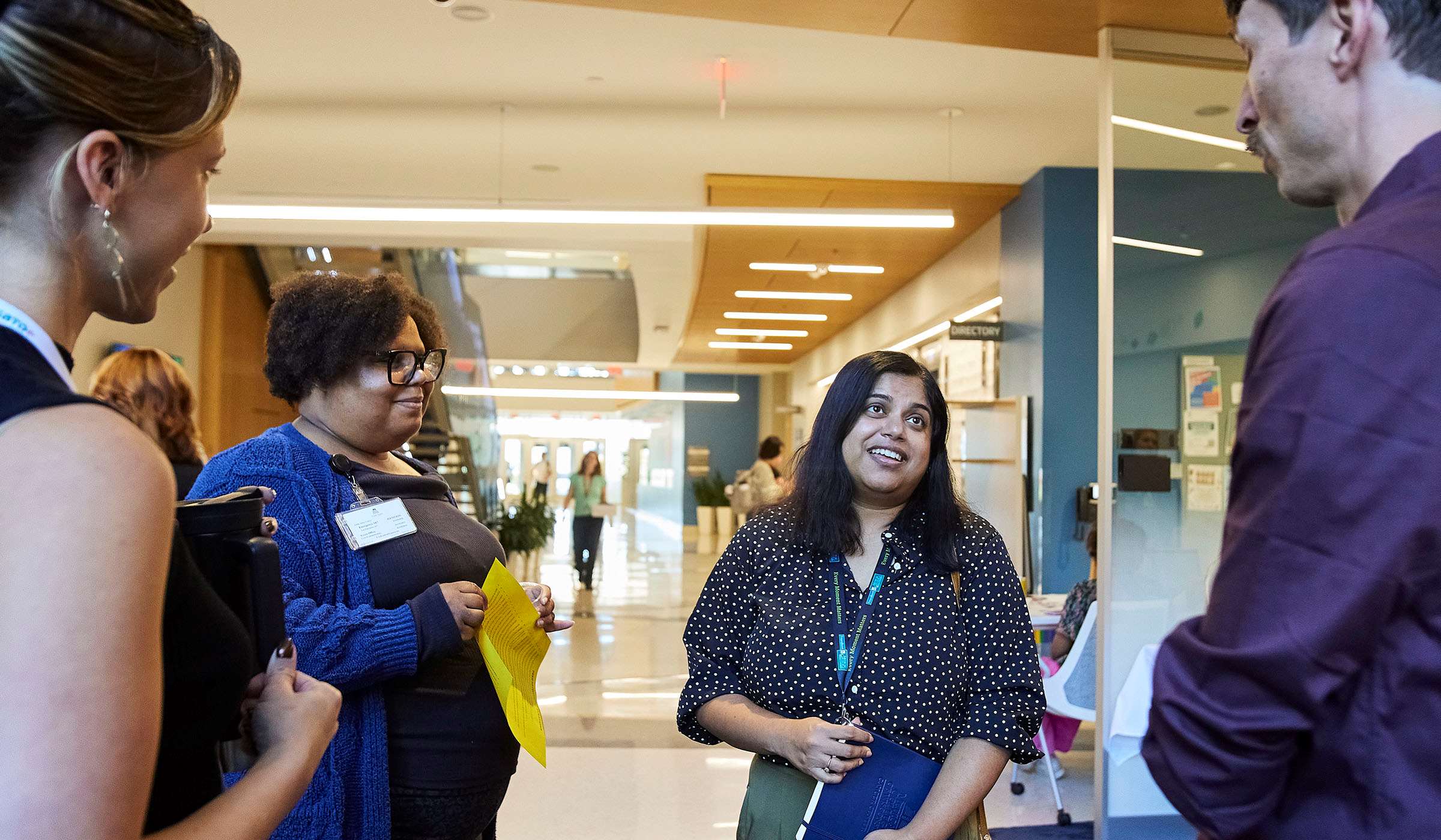 MCW staff talking in lobby