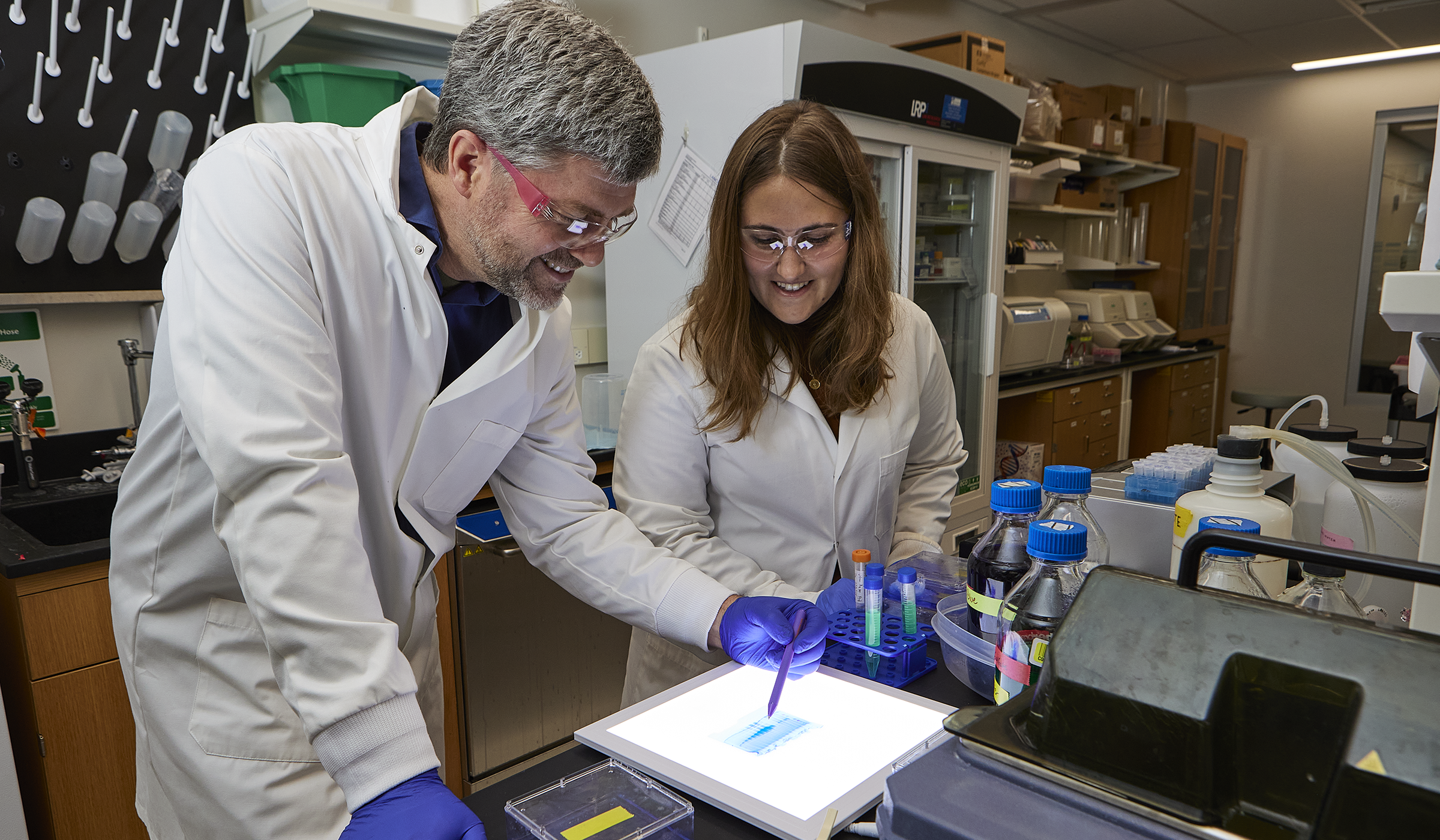 Robert Lochhead, PhD  in immunology lab with a researcher