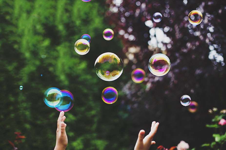 Hands reaching for bubbles
