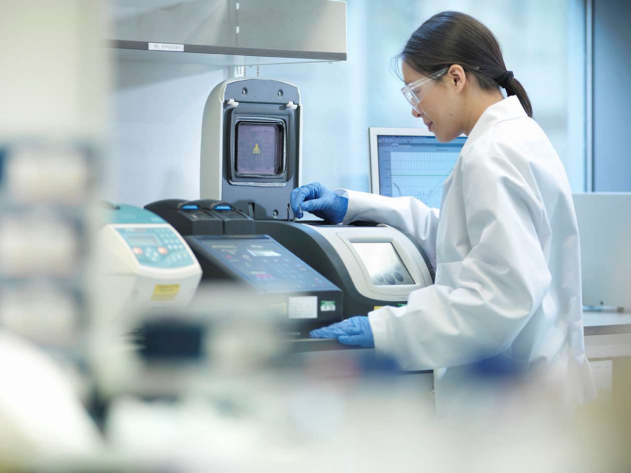 Woman at blood centrifuge machine